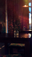 An intimate private dining room decorated with subtle floral arrangements and warm lighting.