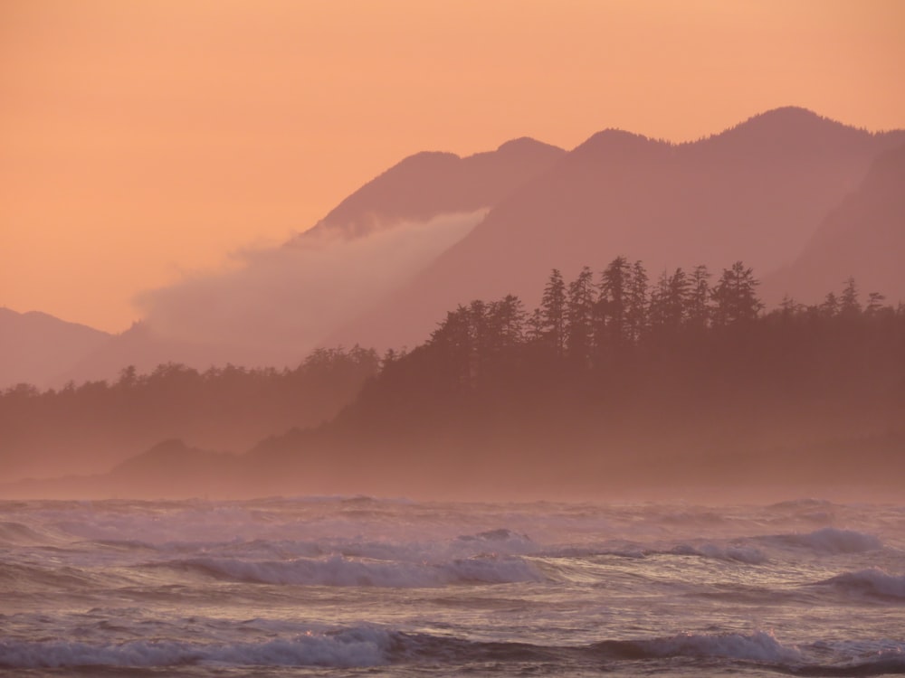 a view of the ocean with a mountain in the background