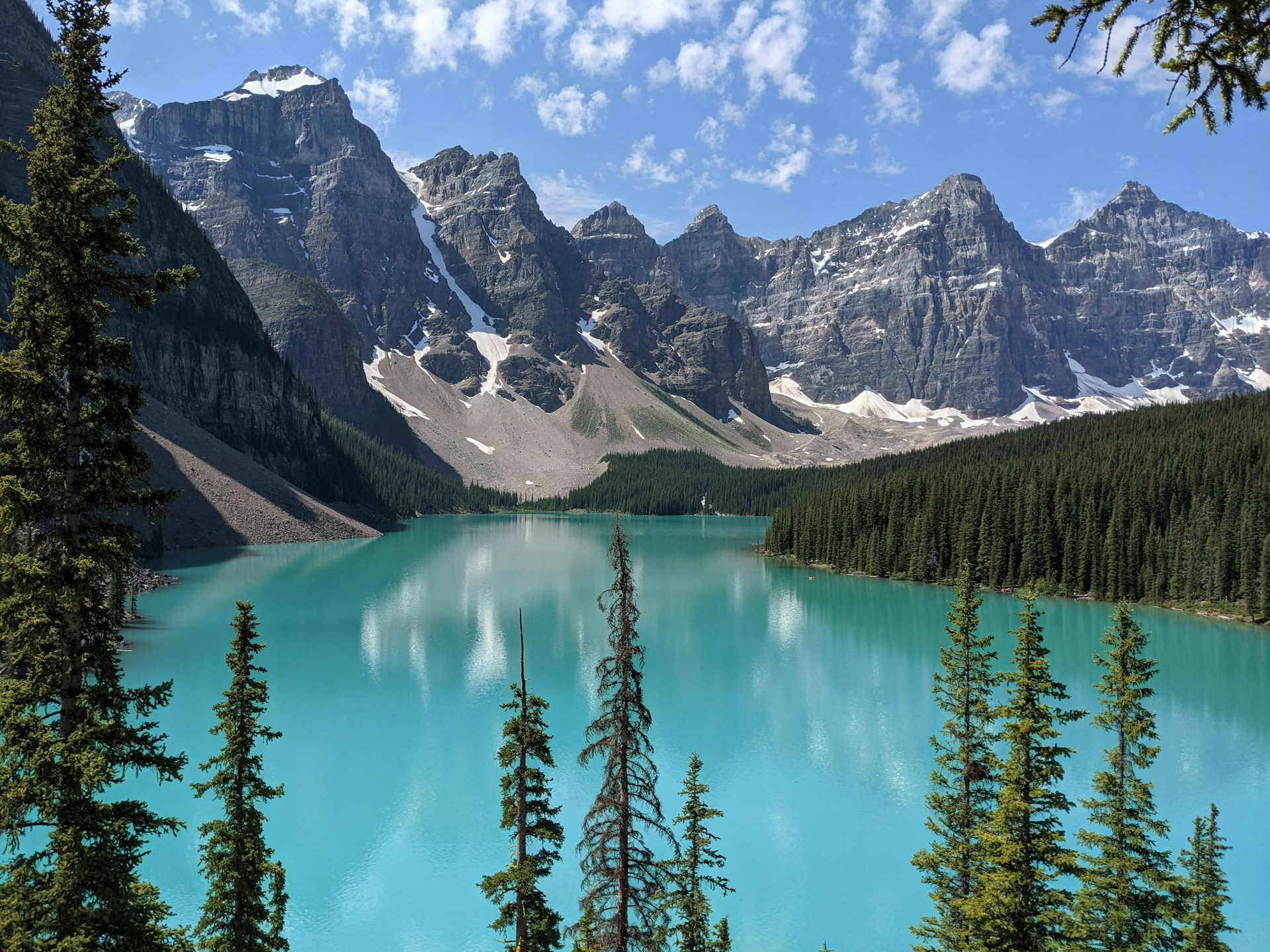 a blue lake surrounded by mountains and trees