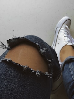 Close-up of a breathable knee pad with reinforced stitching on a wooden floor.