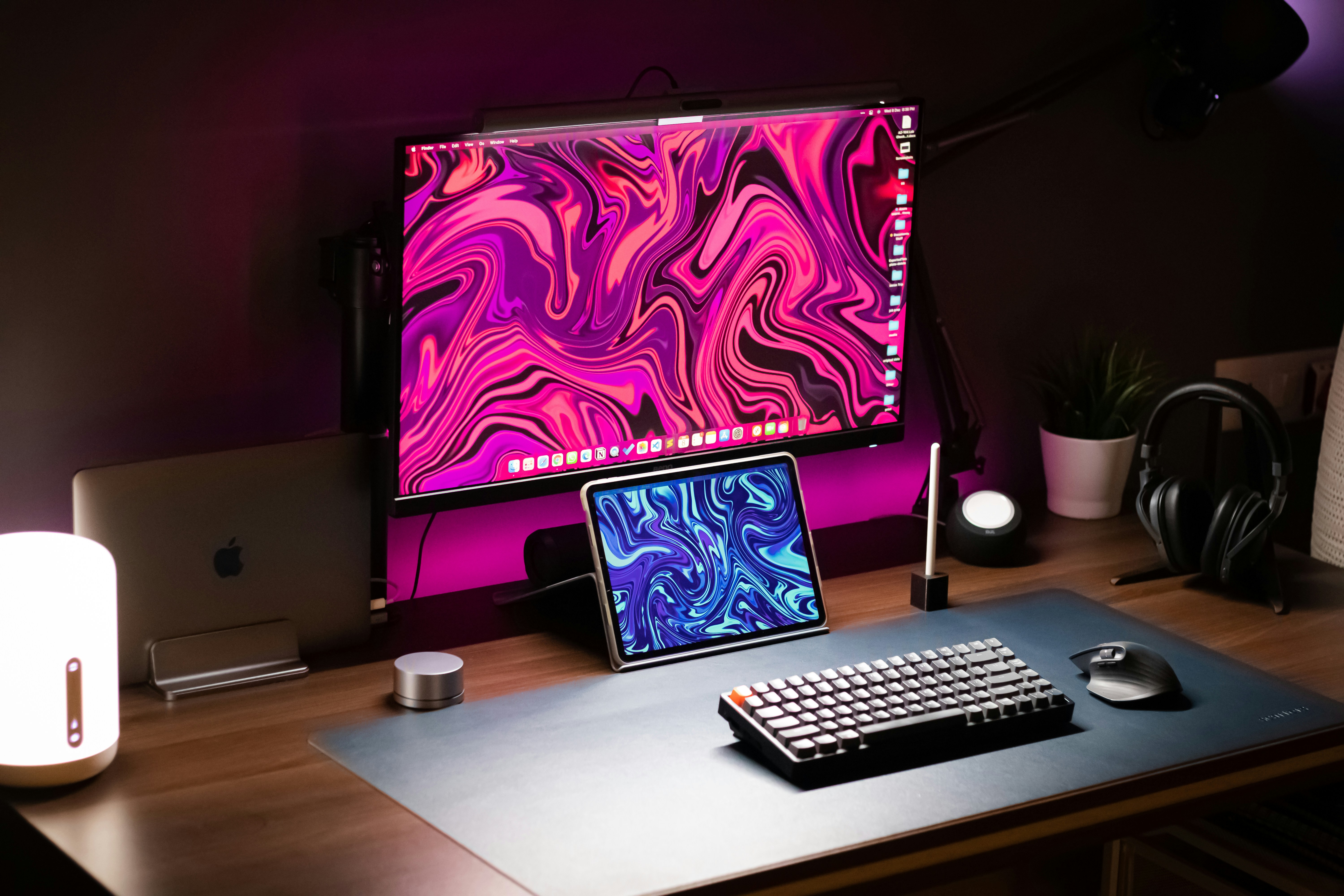 a desk with a keyboard, monitor and mouse