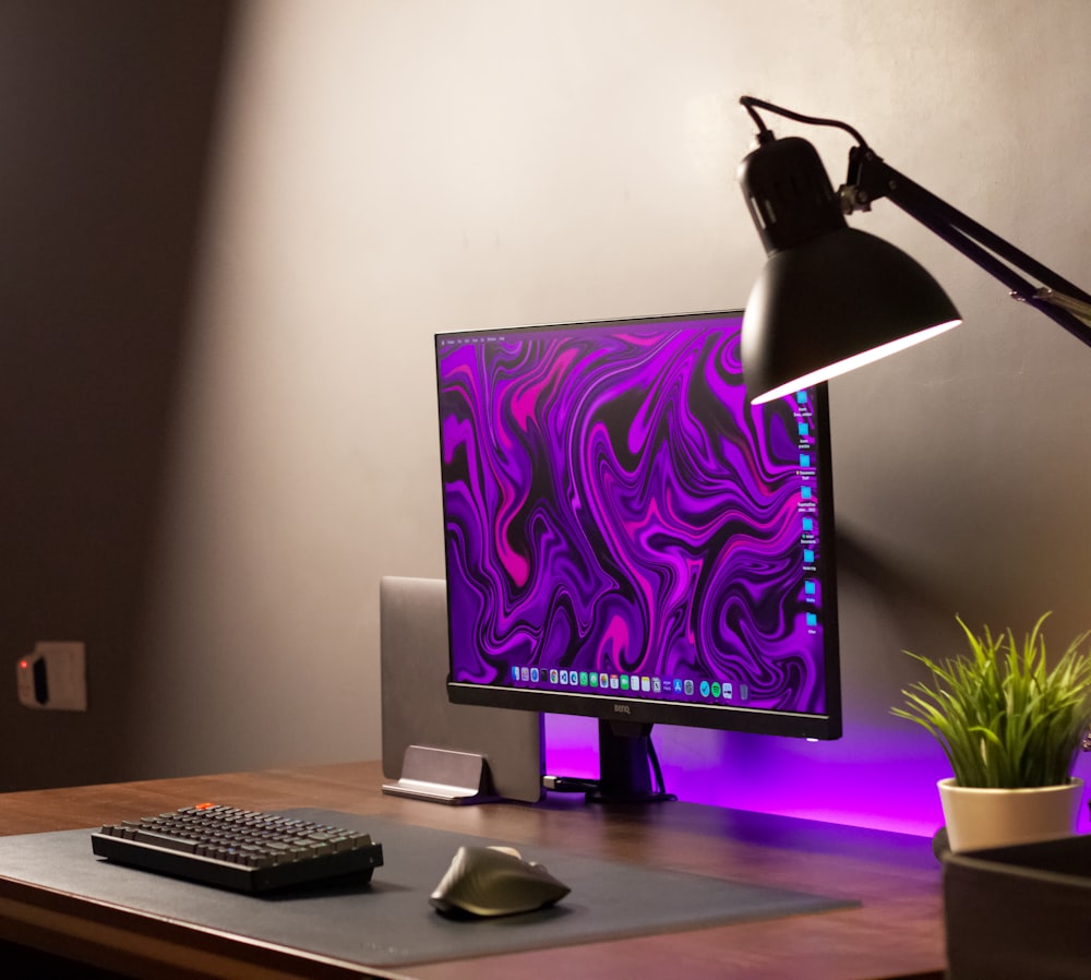 a desktop computer sitting on top of a wooden desk