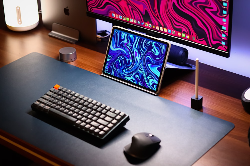 a computer desk with a keyboard, mouse and monitor