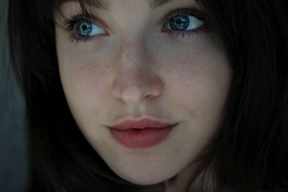 a close up of a woman with blue eyes