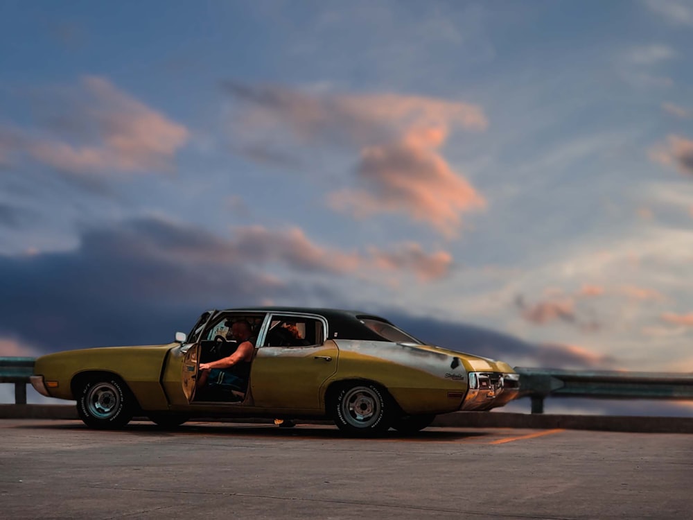 a yellow car parked on the side of the road