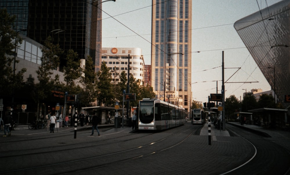 a city street filled with lots of traffic next to tall buildings