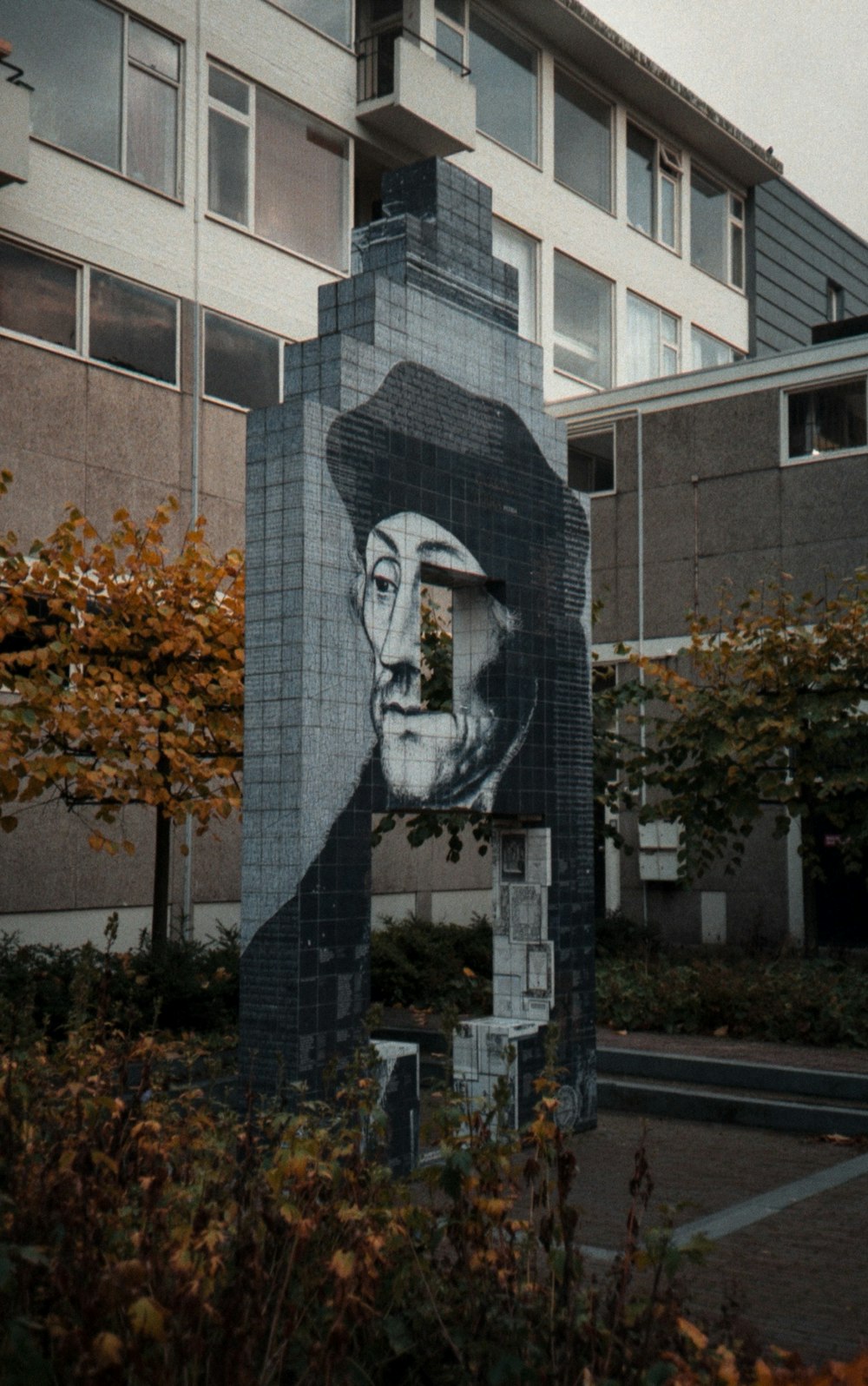 a picture of a man with a hat is on the side of a building