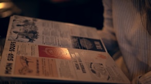 a person is reading a newspaper with a light shining on it