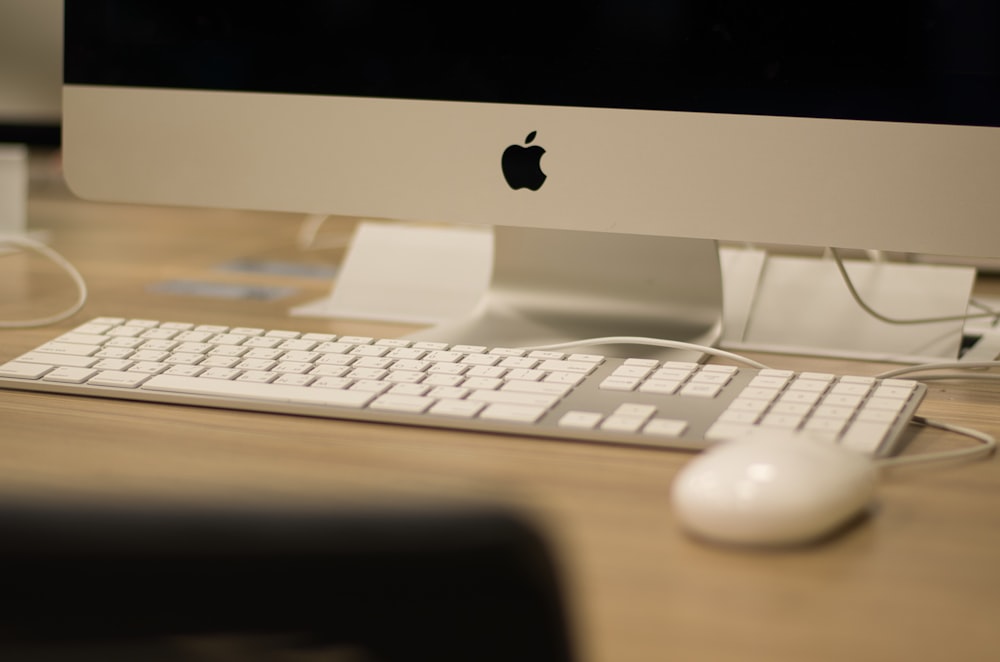 a computer with a keyboard and mouse on a desk