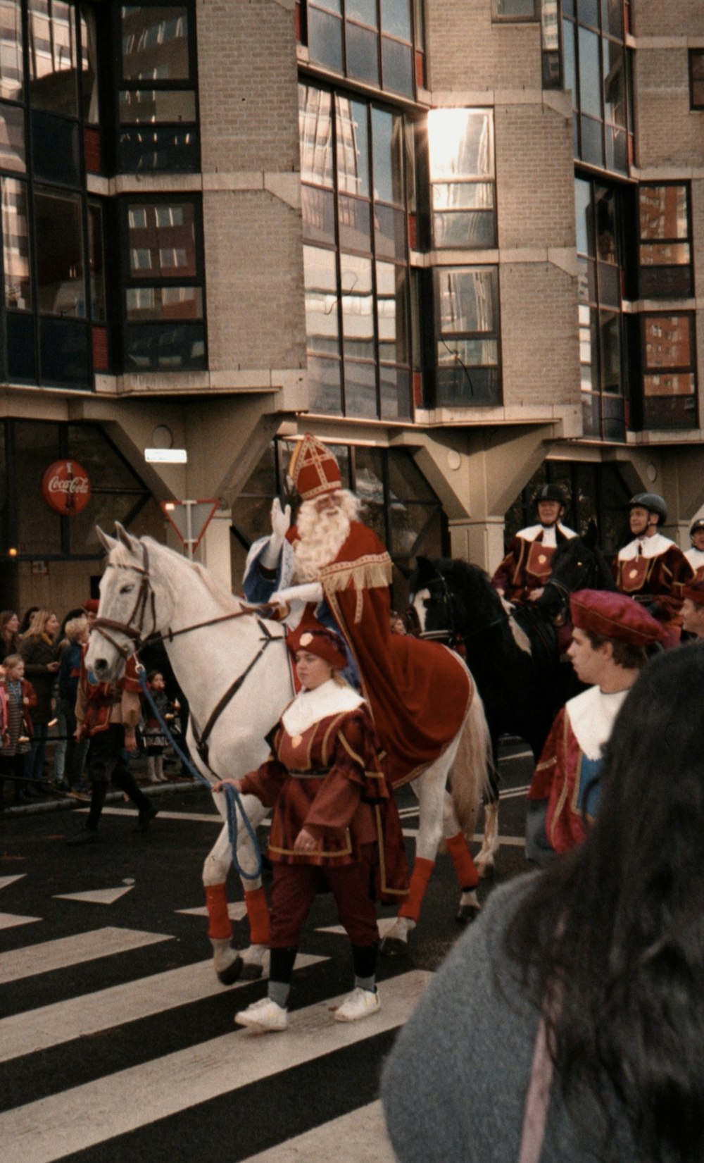 a group of people riding horses down a street