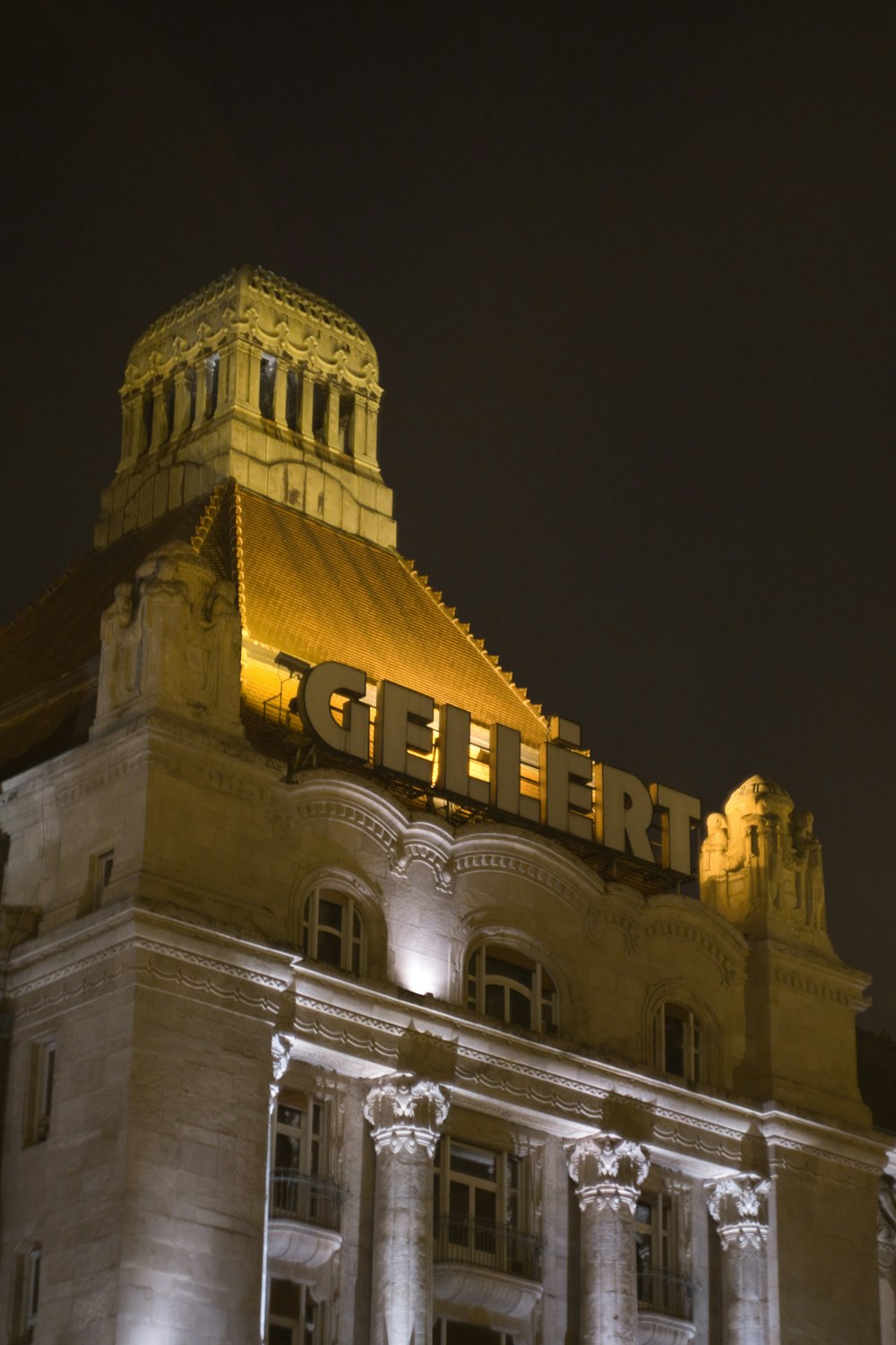 a large building with a lit up sign on top of it