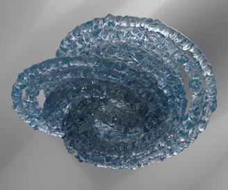 a blue glass bowl sitting on top of a table