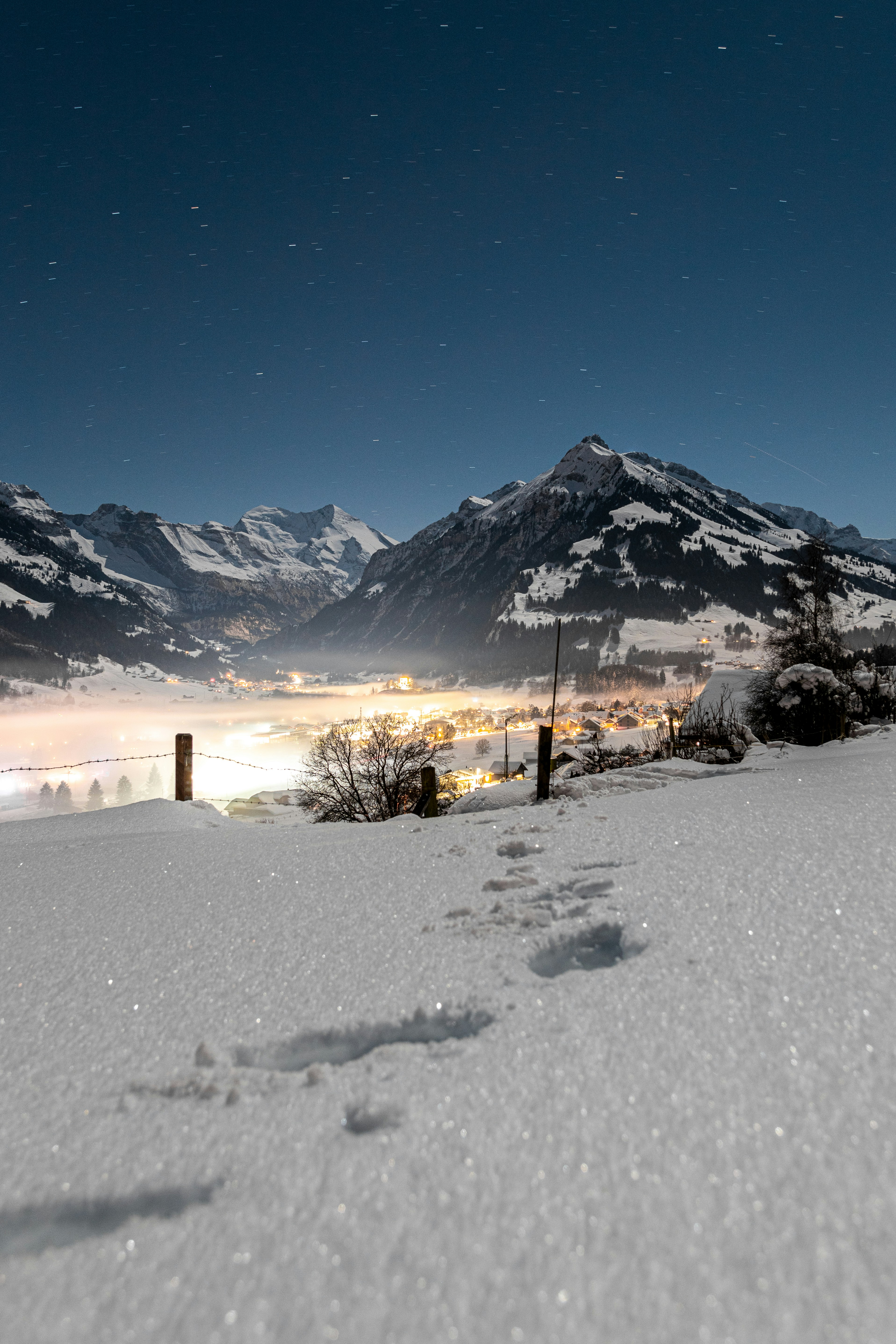 a snowboarder is going down a snowy hill
