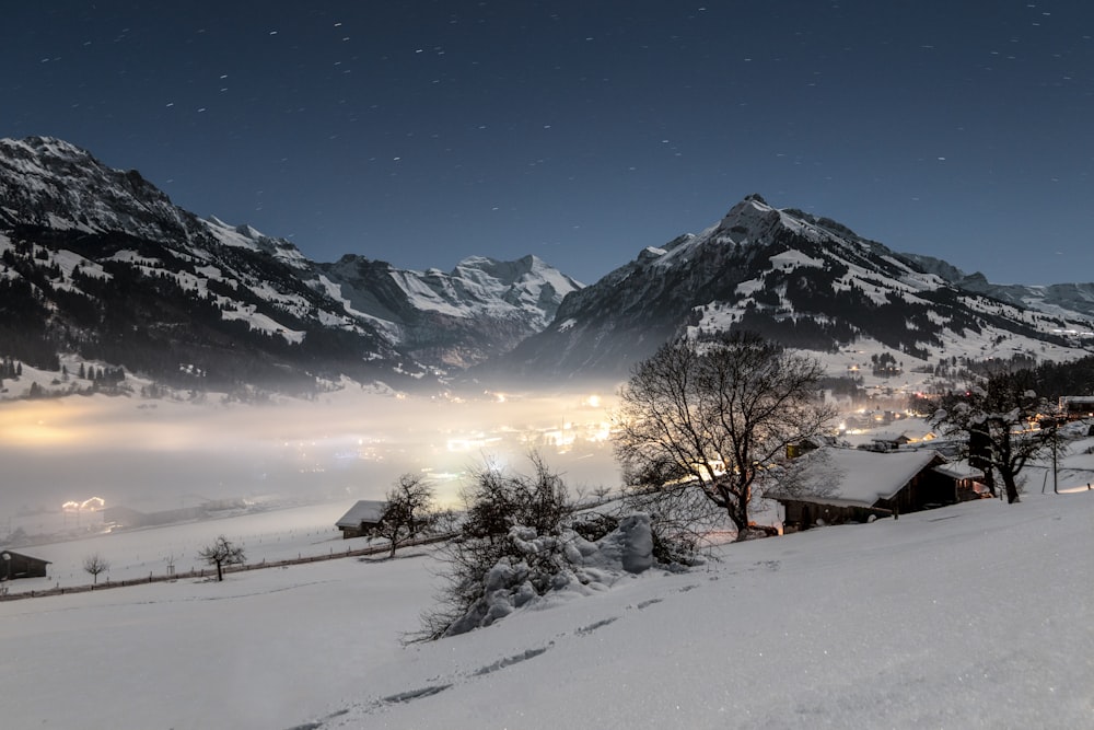 a snow covered mountain with a village in the foreground