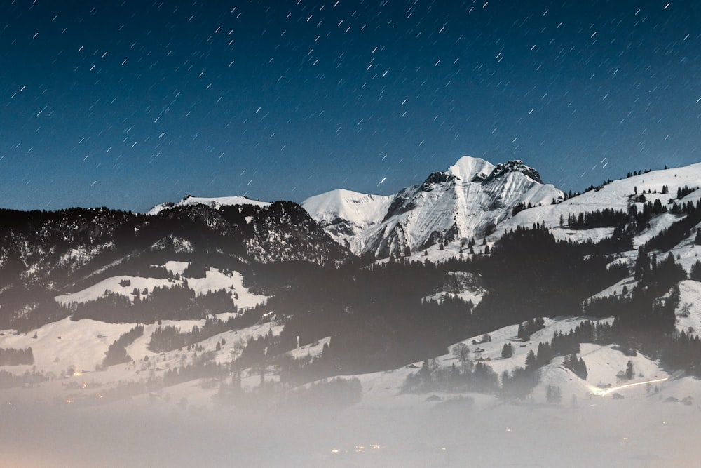 a mountain covered in snow with a sky background