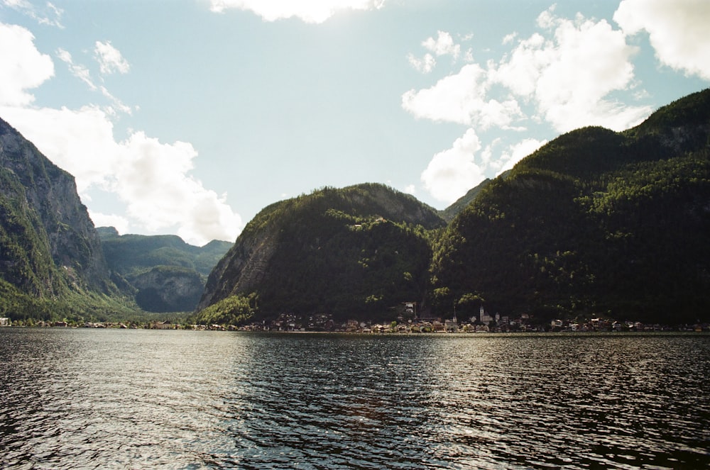 a body of water with mountains in the background