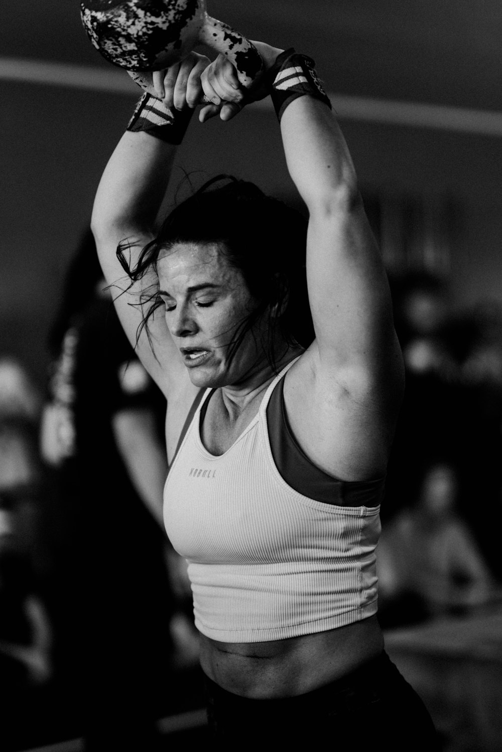 a woman lifting a kettle in a gym