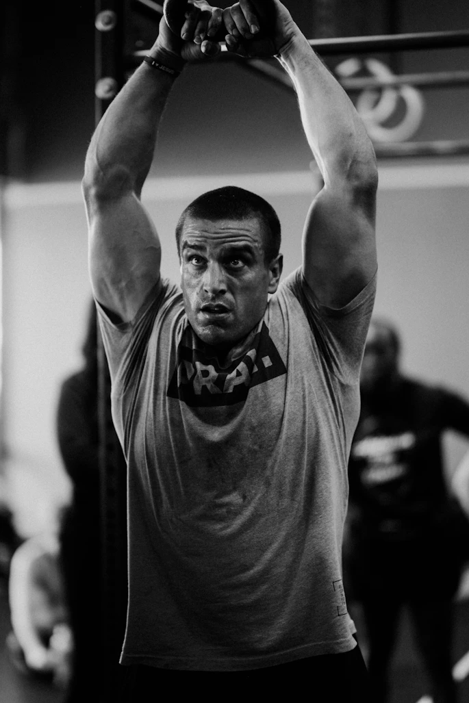 a man in a gym lifting a barbell