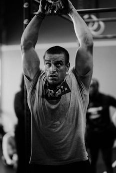 a man in a gym lifting a barbell