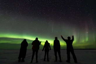 Travelers from Bersama Jalan Santai admiring the Northern Lights in Iceland