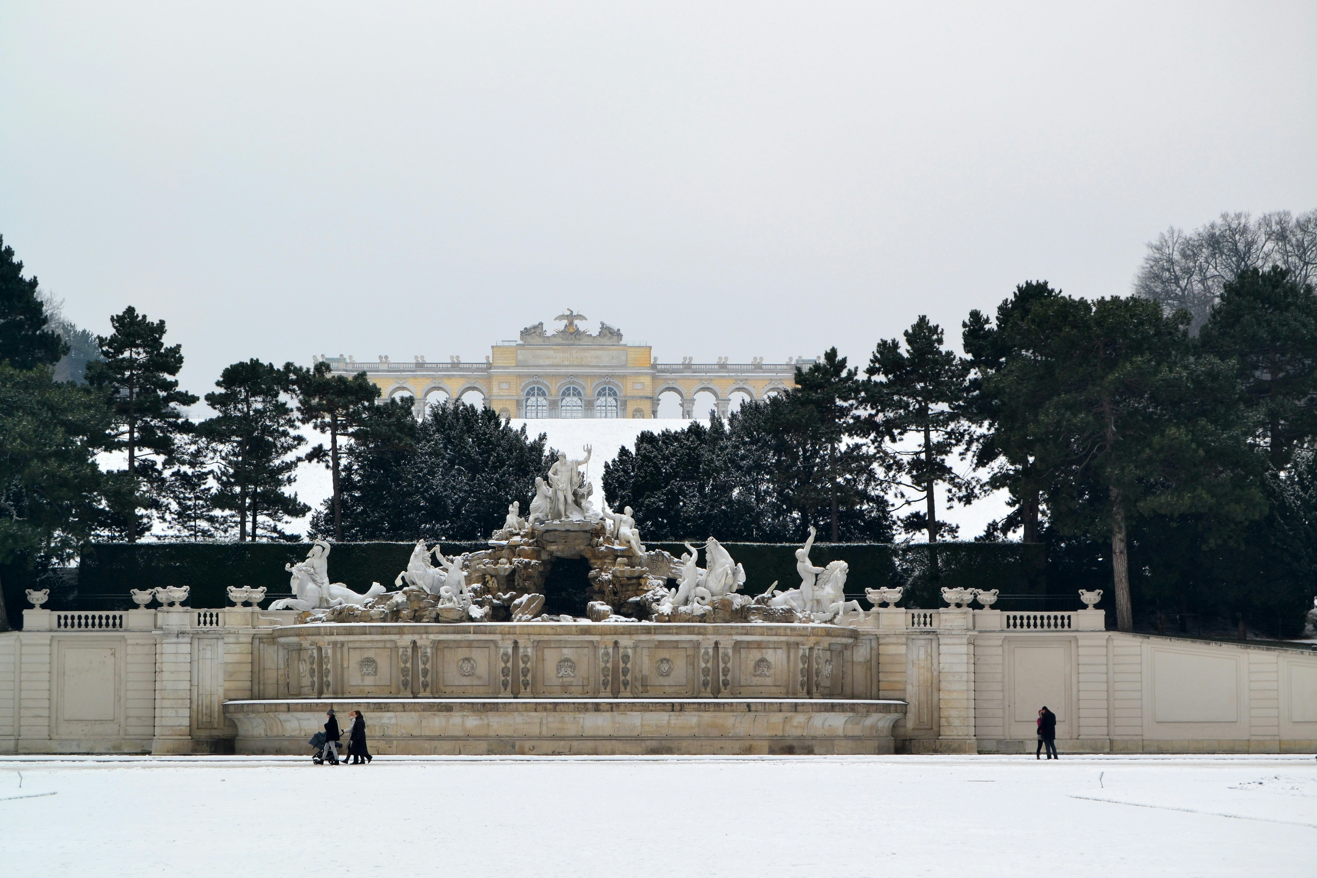 two people are standing in front of a fountain