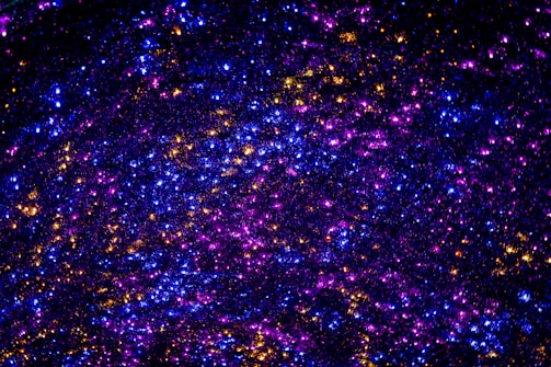 A shimmering cosmic bracelet glowing softly against a backdrop of swirling galaxy dust and stars.