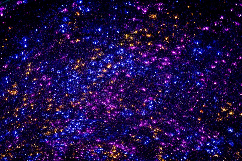 A shimmering cosmic bracelet glowing softly against a backdrop of swirling galaxies and stardust.