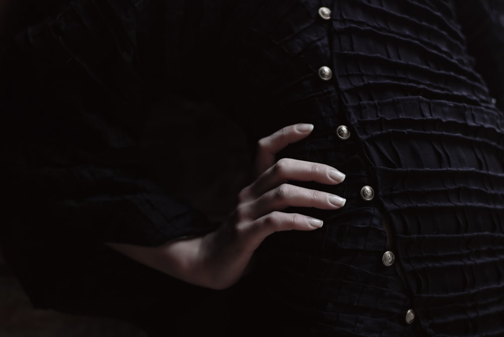 a close up of a person's hand on a dress