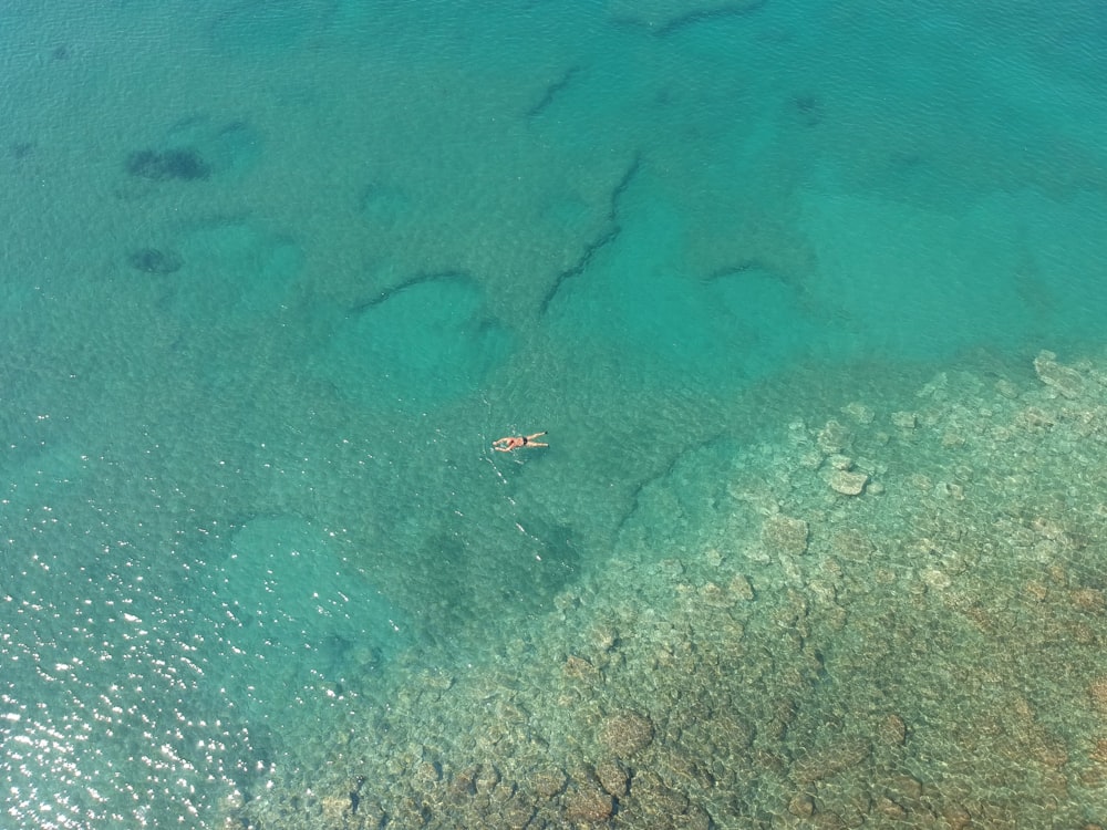 an aerial view of a boat in the water