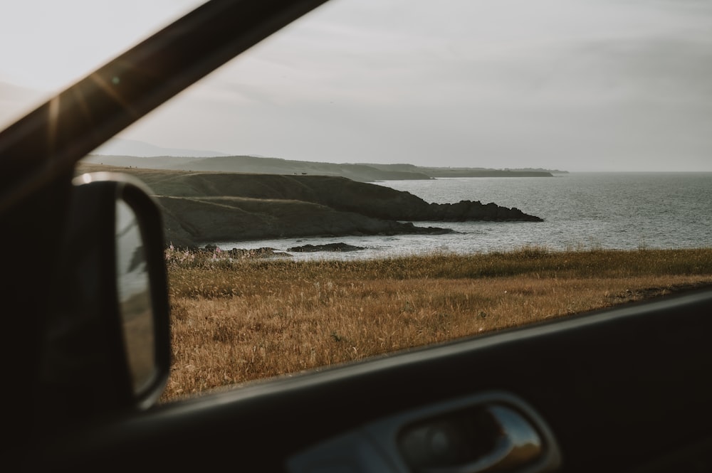 a view of a body of water from inside a vehicle