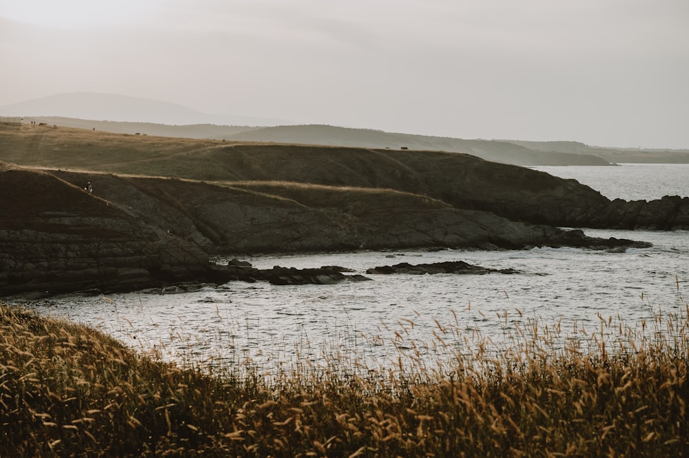 a body of water surrounded by a rocky shore