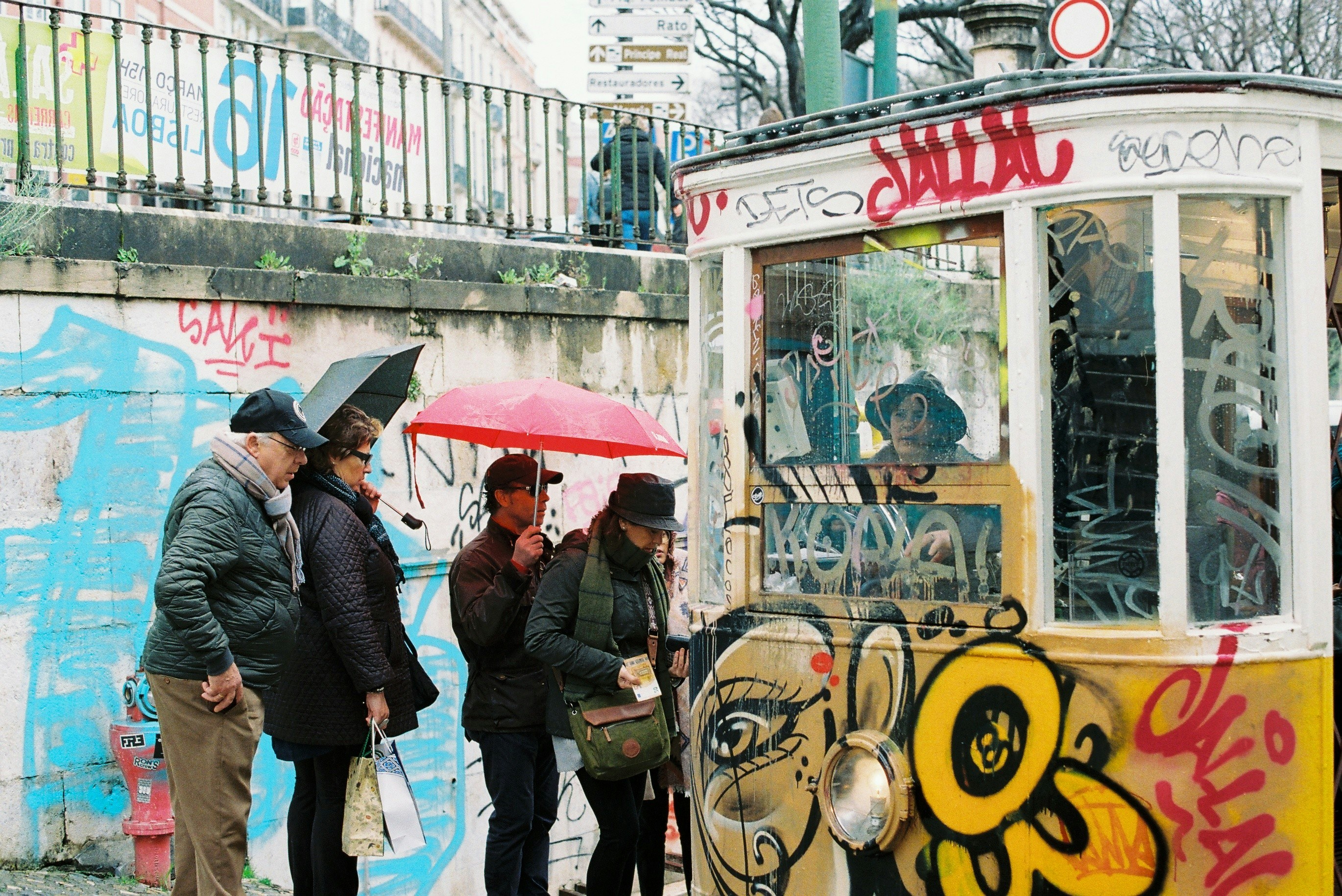 a group of people standing in front of a trolly
