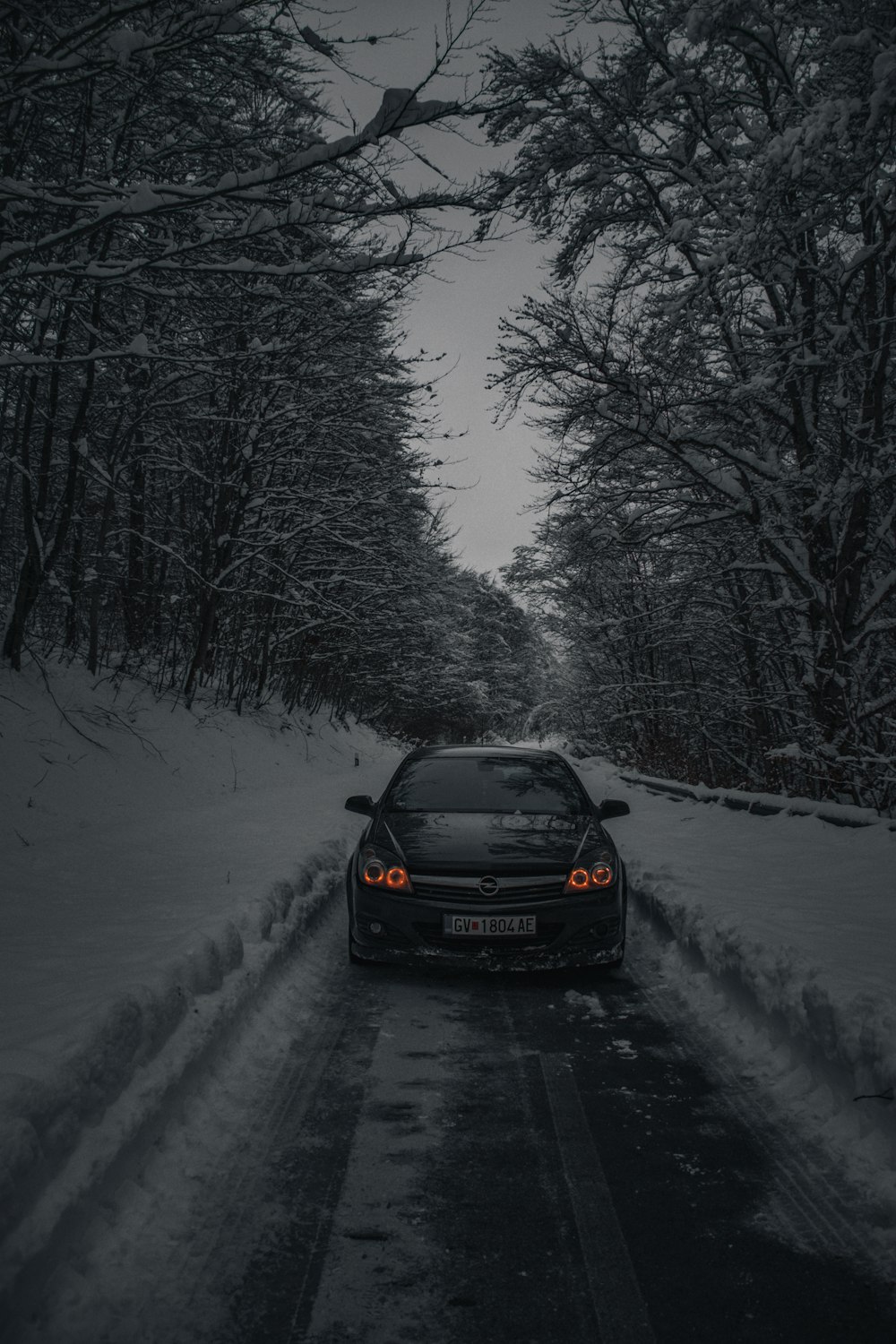 a car driving down a snow covered road