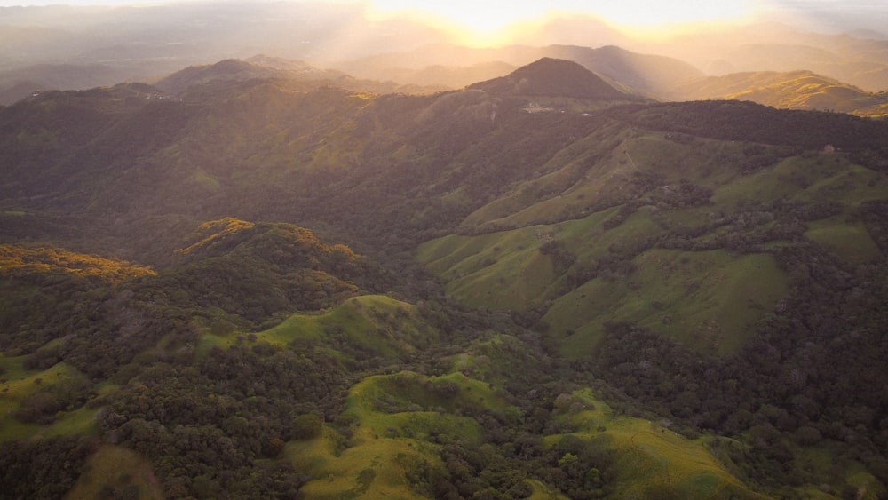 an aerial view of a mountain range at sunset