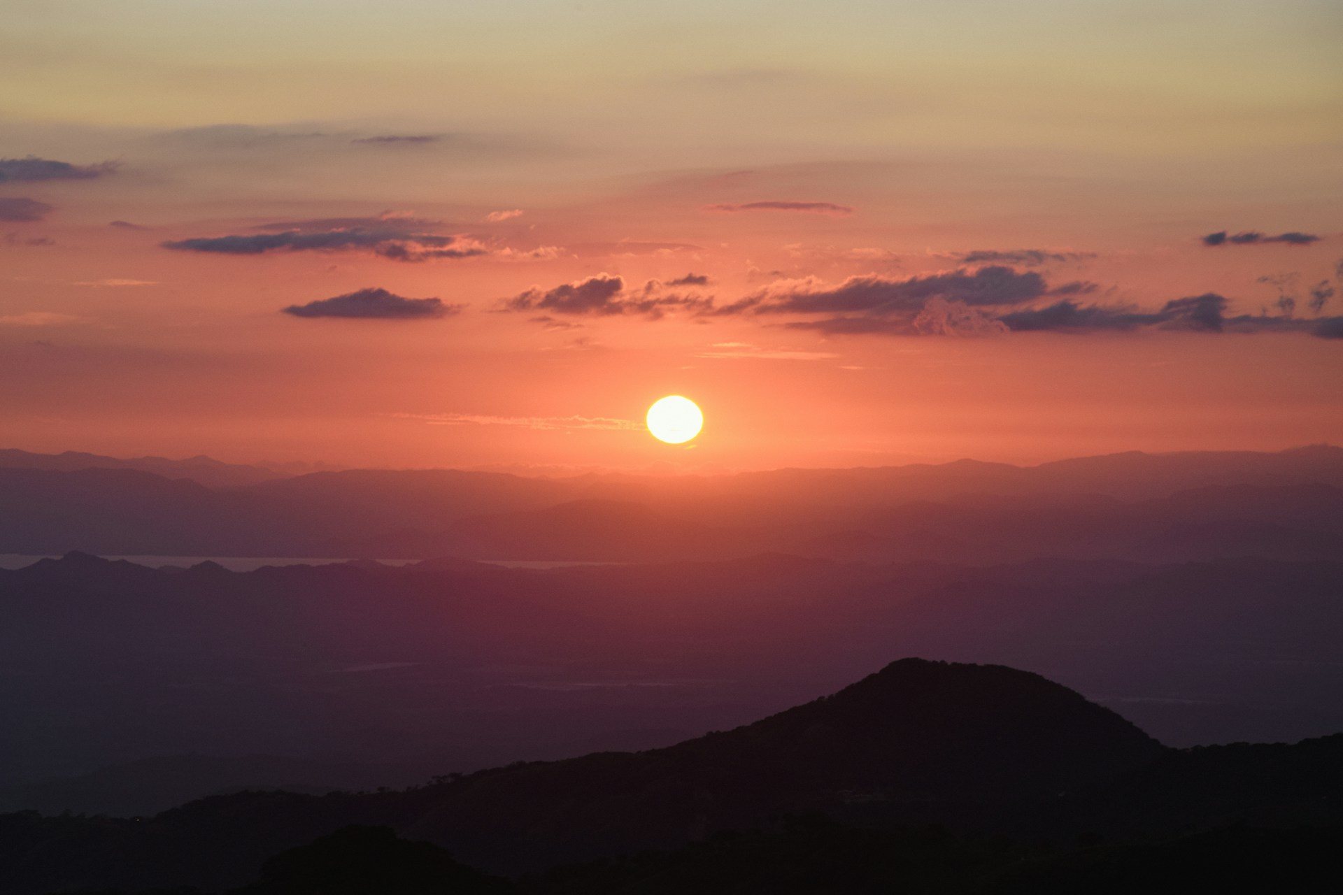 A vibrant sunset over the Holy Mountain, casting a warm glow on the surrounding landscape.