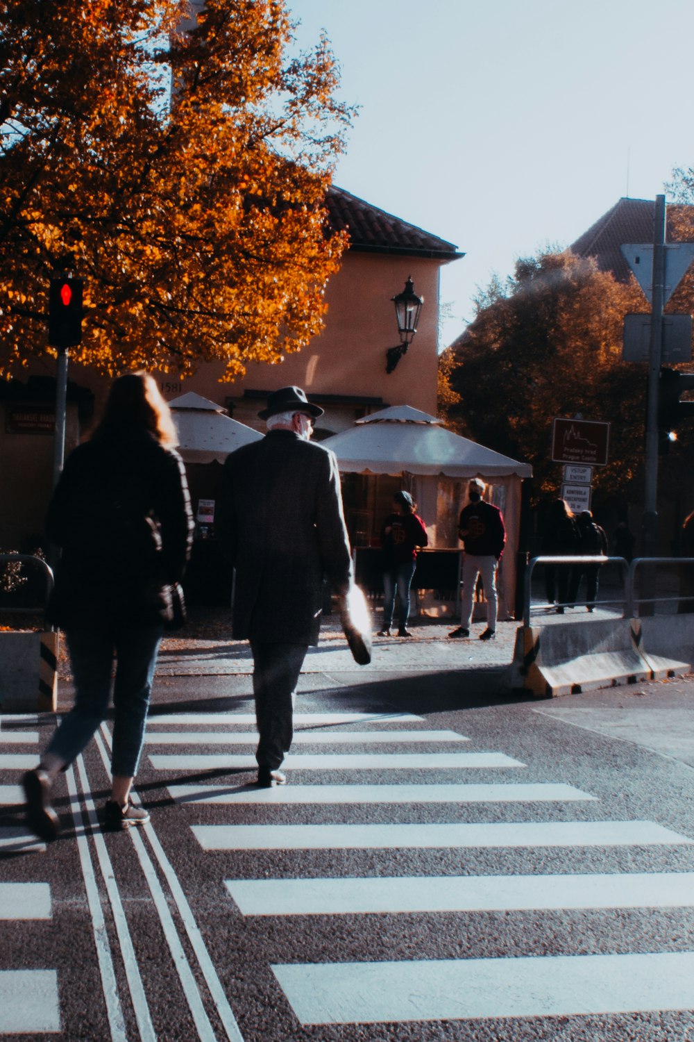 a couple of people that are walking across a street