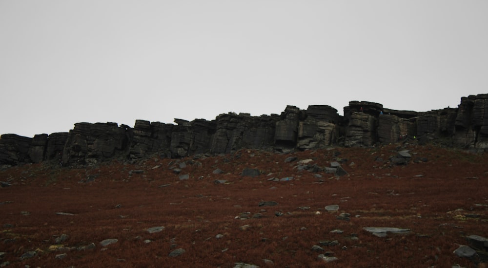 a large rock formation on the side of a hill