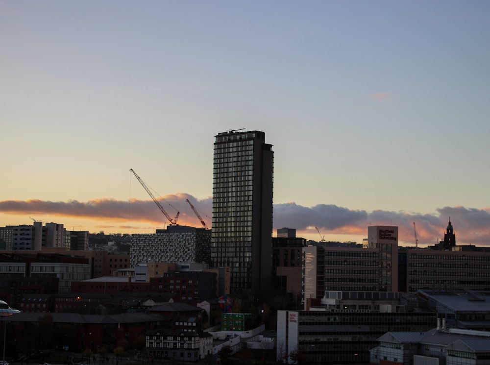 a view of a city at sunset with a few clouds