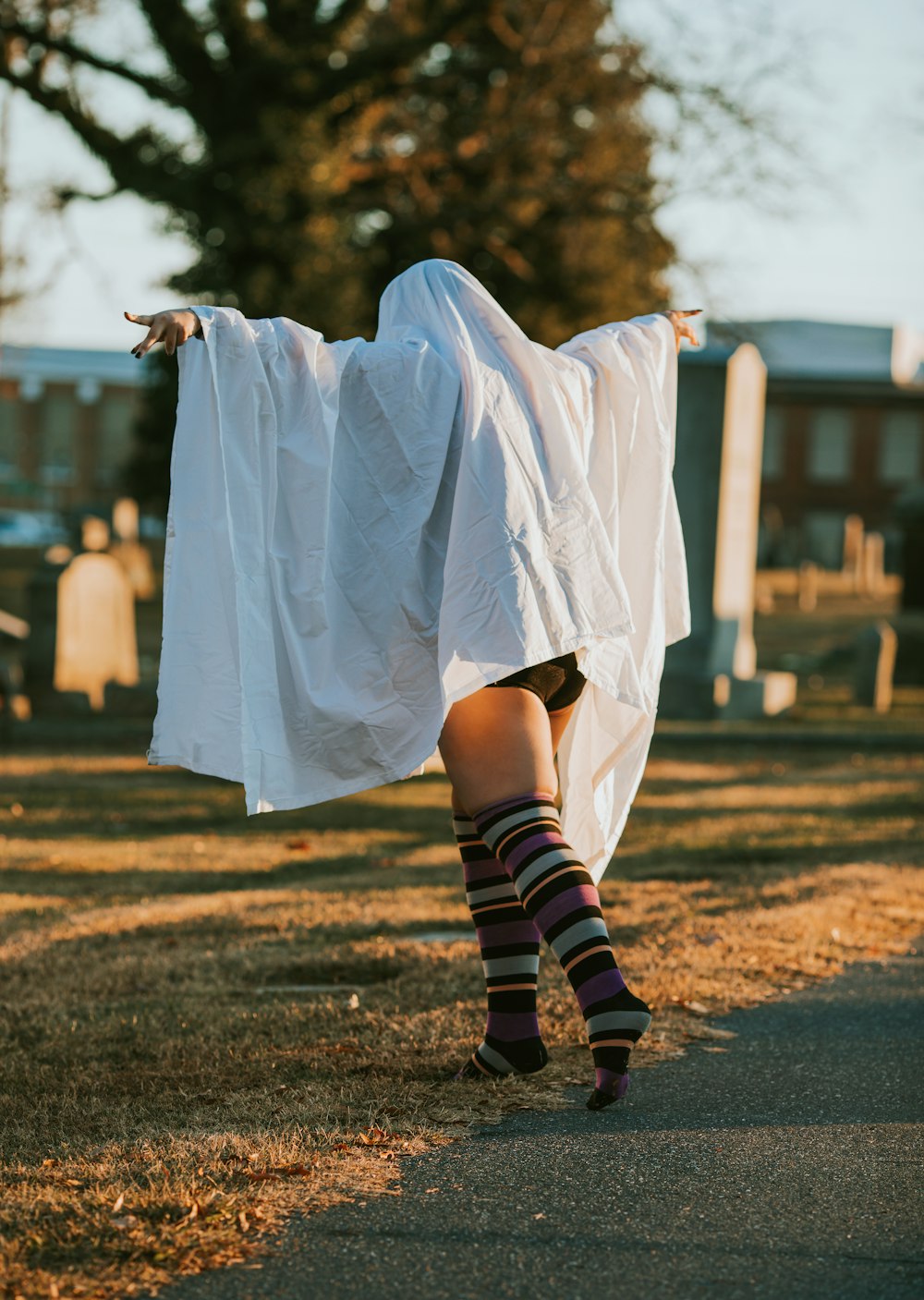 a woman in a white dress and striped socks