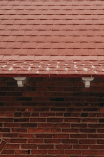 a red brick building with a clock on the side of it