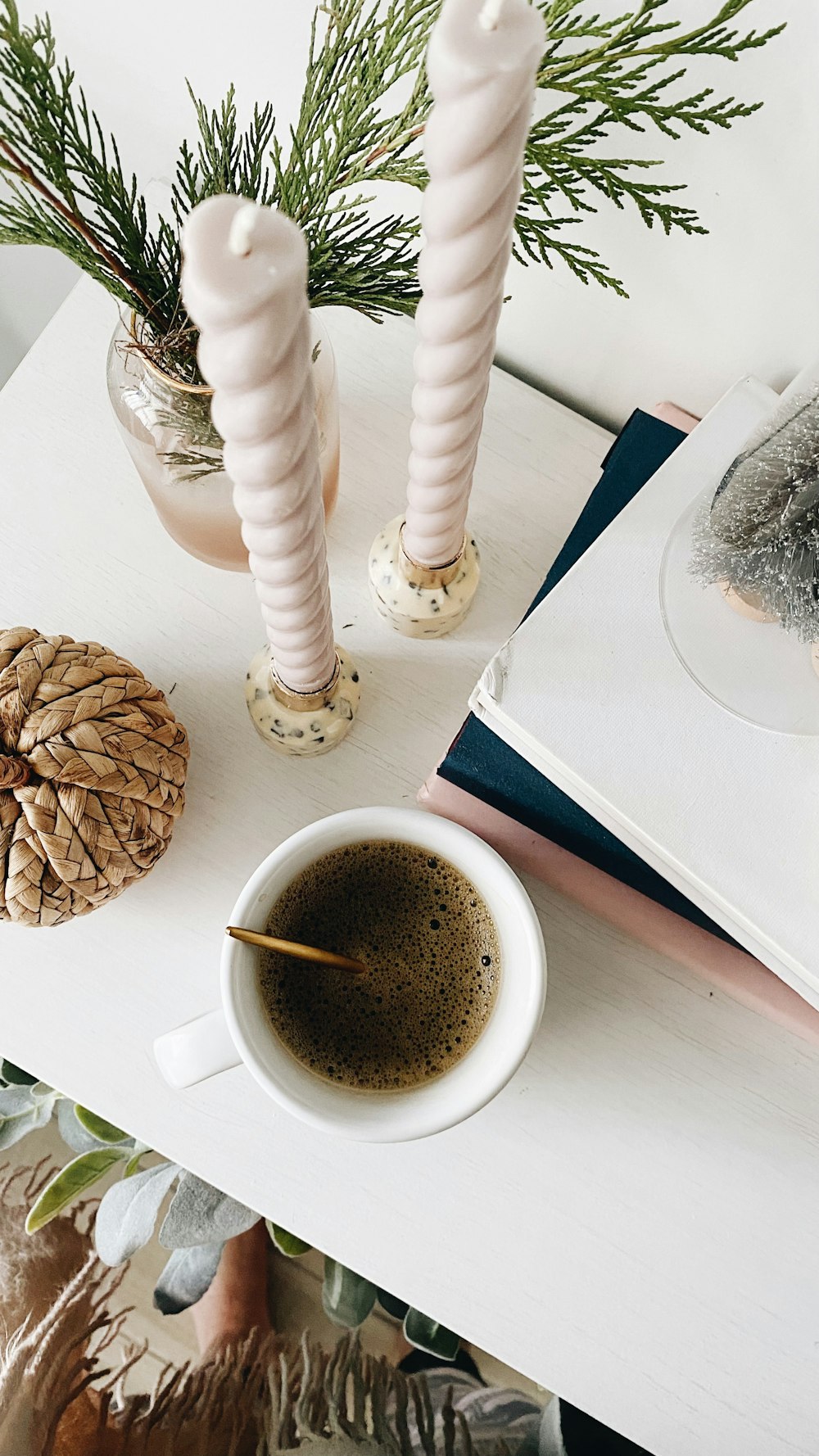 a cup of coffee sitting on top of a white table