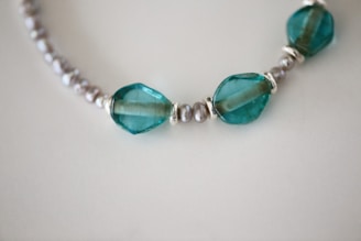 A baby teething necklace in soft celeste tones, designed for comfort and style.