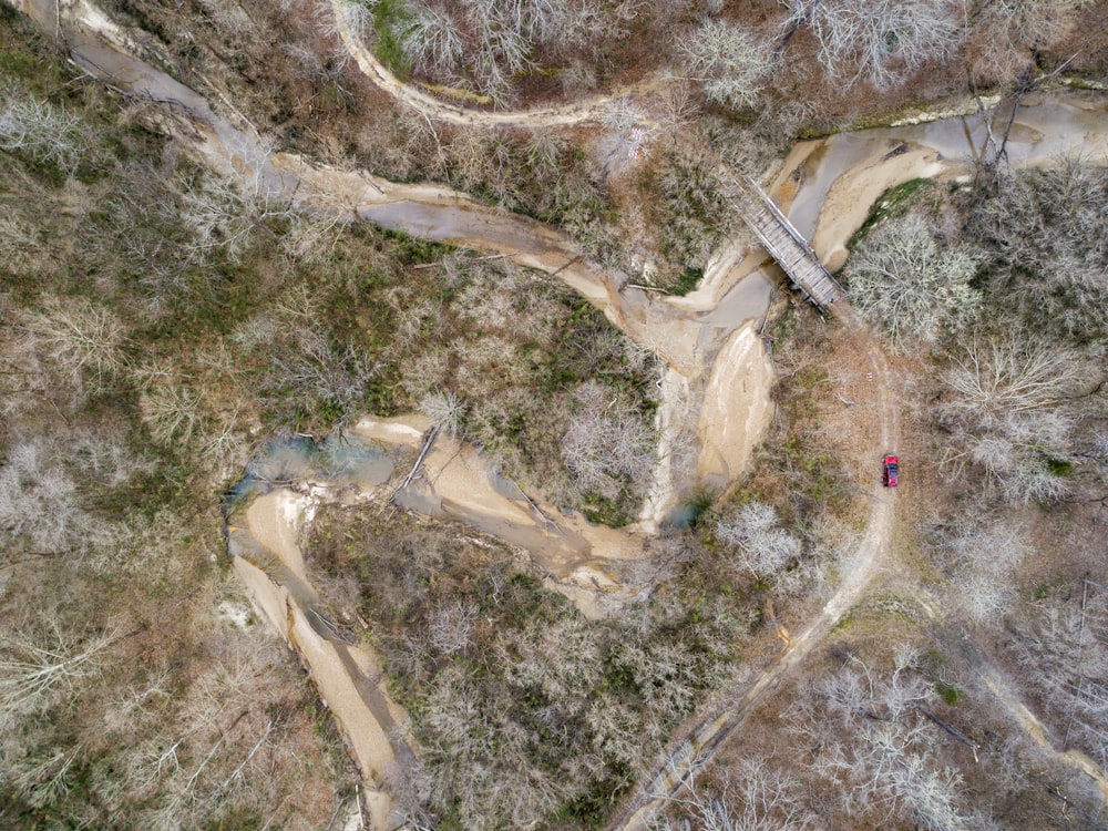 an aerial view of a winding road in the woods