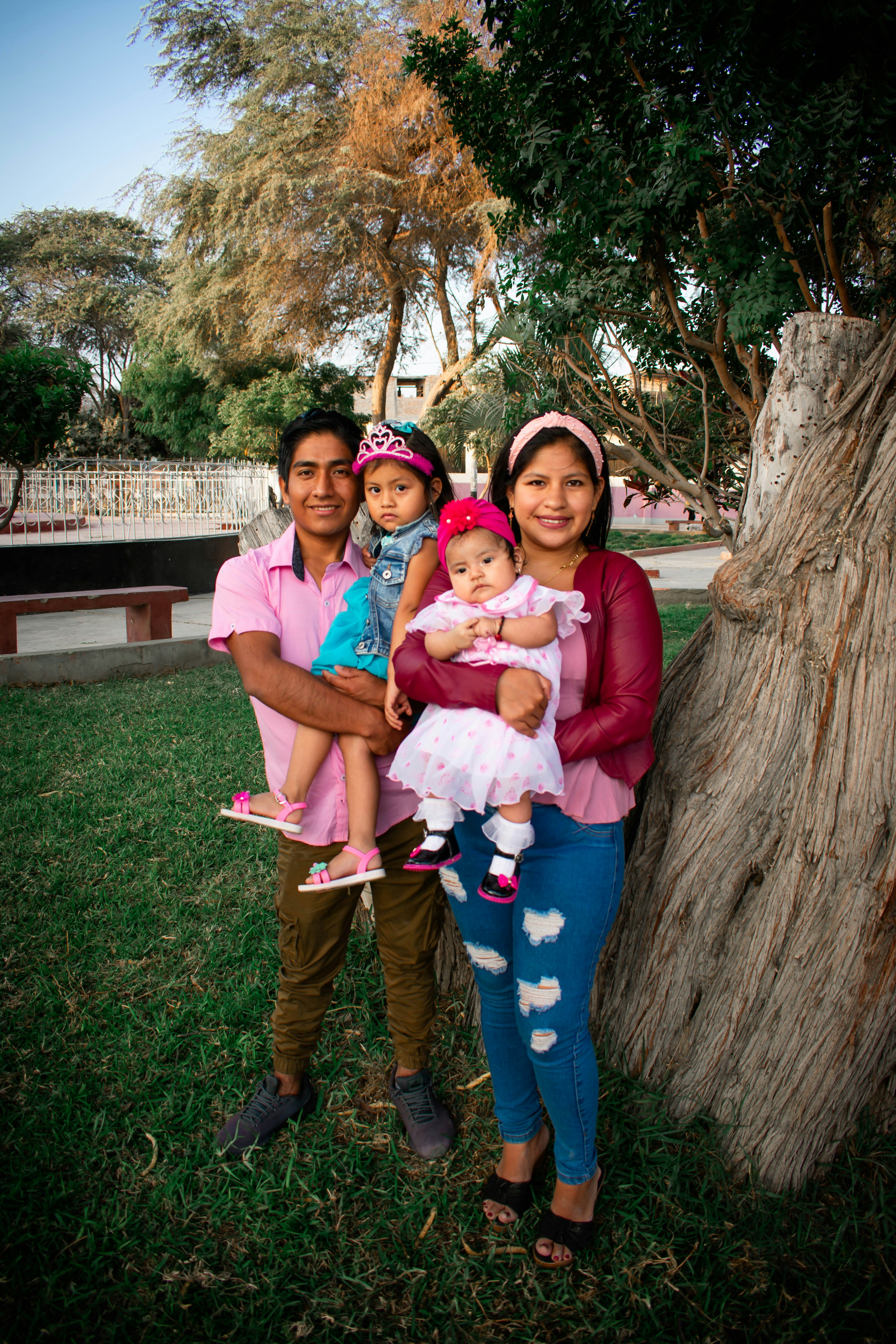 Indian military family portrait, mother with children in outdoor setting, warm golden light, bright cheerful atmosphere