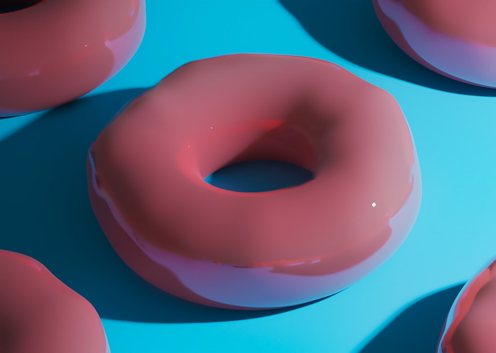 a group of donuts sitting on top of a blue surface
