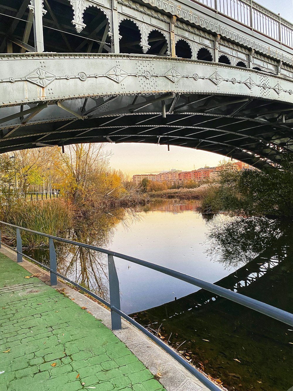 a bridge over a body of water next to a sidewalk