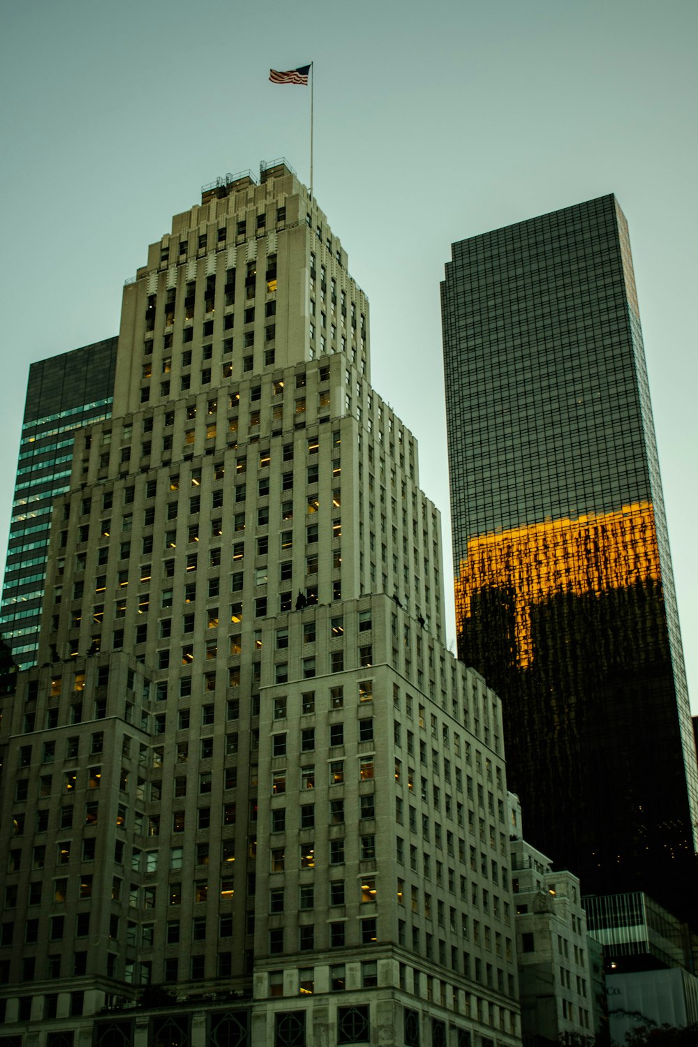 a tall building with a flag on top of it