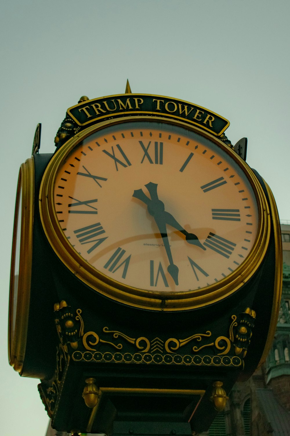 a gold and black clock with roman numerals