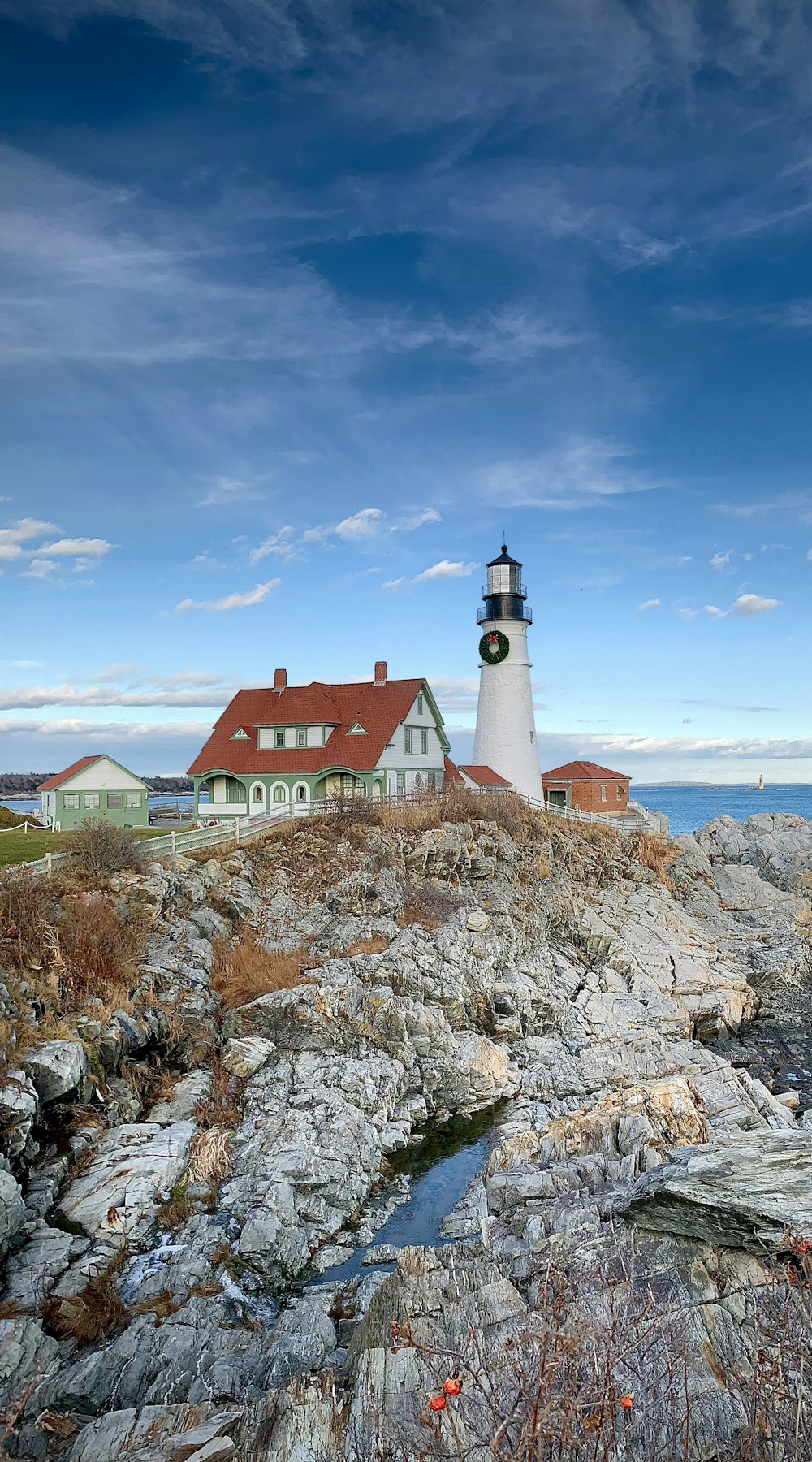 a lighthouse on top of a rocky outcropping