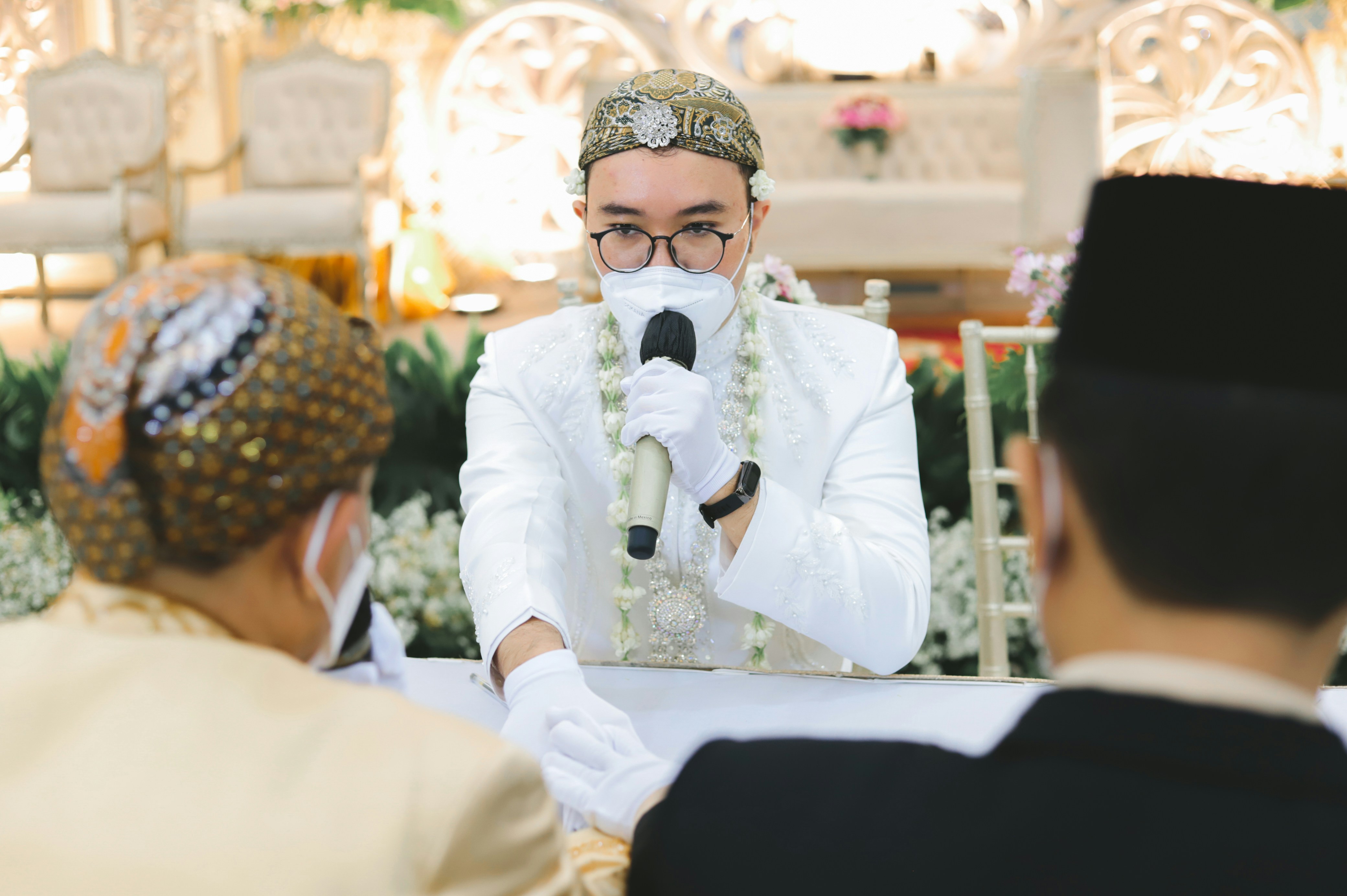 a man in a tuxedo holding a microphone